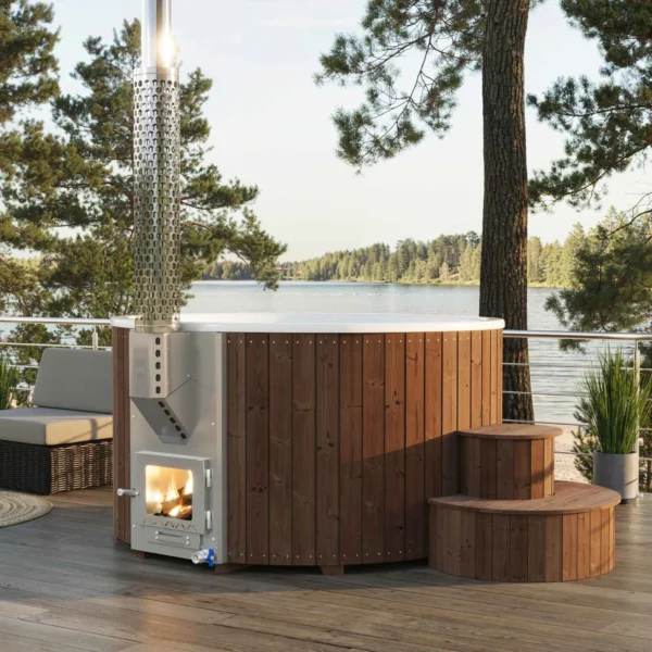 Yoshino Kumano brown pine wood hot tub on a deck overlooking a lake, silver marine aluminum heater with glass door, aesthetic chimney design, and natural surroundings with pine forest.
