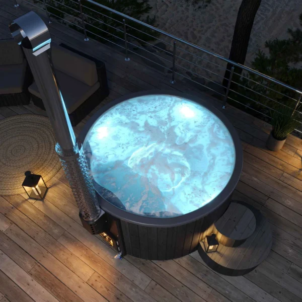 Yoshino Kumano hot tub on an evening deck with glowing blue LED lighting, thermally treated pine wood exterior, marine aluminum heater, and comfortable wooden steps for a relaxing experience.