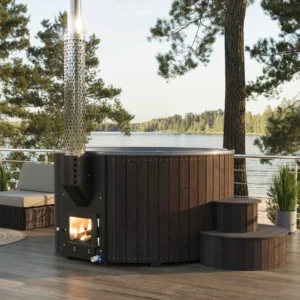 Yoshino Kumano black thermally treated pine wood hot tub on lakeside deck, visible fireplace, distinctive marine aluminum chimney, and stepped design for comfortable access.