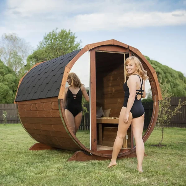 Wooden barrel sauna with mirrored panels for outdoor use.