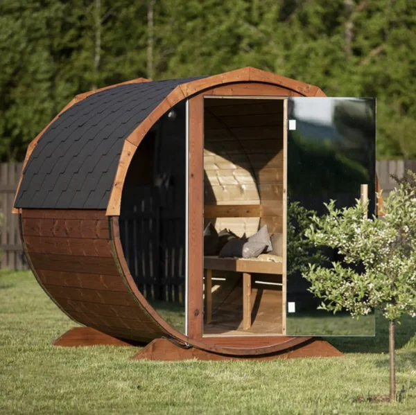Wooden barrel sauna with mirrored panels for outdoor use.