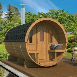 Thermowood barrel sauna with a changing room and terrace. Weather-resistant Nordic design, ideal for lakeside retreats and outdoor living.