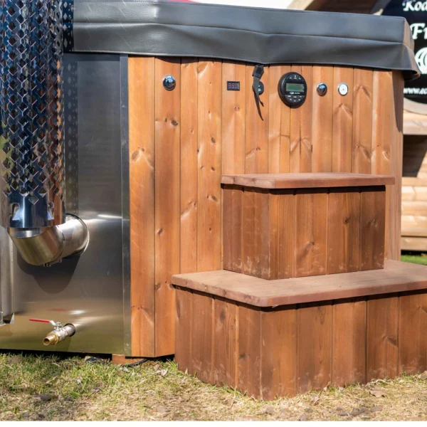 The "BubbleKing XXL" hot tub provides a spacious and luxurious relaxation experience for up to 10 people. It features an ergonomic octagonal fiberglass insert (available in Gray, Blue, or White), durable thermowood walls, and an integrated stainless steel heater (30kW) with a 2-meter chimney. With its 2400-liter capacity, it's perfect for gatherings or quiet evenings. Optional LED lighting, air bubble system, and Bluetooth speakers enhance the experience further.