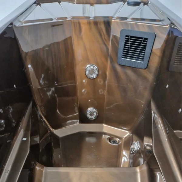 Close-up view of the Lumi Solo hot tub interior, showing hydro massage jets and the ergonomic seating area for one.